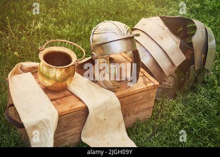 Ancient Roman weapons and armor - helmets and chain mail. Reconstruction of military events during the wars of the Roman Empire Stock Photo