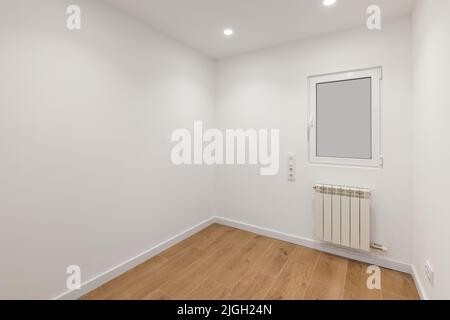 Empty room with frosted glass to avoid watching by neighbours. Laminate flooring and newly painted white walls in refurbished apartment. Stock Photo