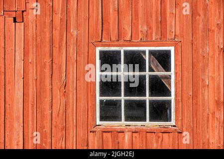 Red weathered barn with a window Stock Photo