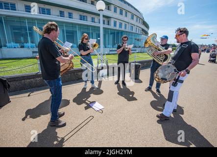 More Music’s annual kite festival returns to Morecambe. Instrument players  outside he famous art deco Midland Hotel on the promenade at Morecambe. Stock Photo