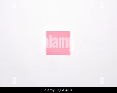 Blank or empty pink notepaper or notepad on white background. Stock Photo