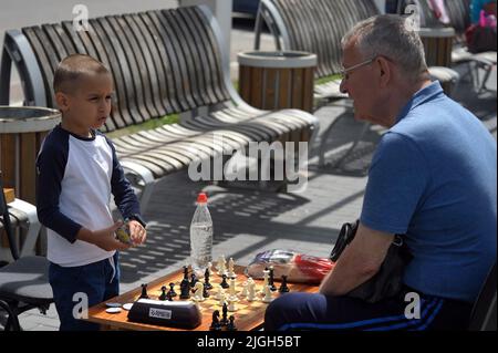 VINNYTSIA, UKRAINE - JULY 10, 2022 - Five-year-old chess prodigy Artem Kucher plays with a man during a charity chess match in support of the Ukrainia Stock Photo