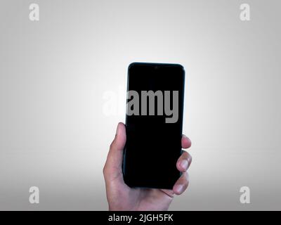 Hand businessman showing smartphone with blank screen, isolated on white background, copy space clipping path Stock Photo