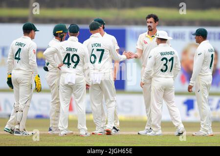 Galle, Sri Lanka. 11th July 2022. Mitchell Starc of Australia celebrates with teammates after taking the wicket of Prabath Jayasuriya of Sri Lanka during the 4th day of the 2nd test cricket match between Sri Lanka vs Australia at the Galle International Cricket Stadium in Galle on 11th July, 2022. Viraj Kothalwala/Alamy Live News Stock Photo