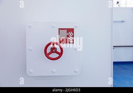 cabinet with steering wheel on boat for fire equipment Stock Photo