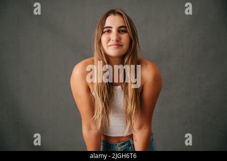 Close up Caucasian female long blond hair smiling in casual wear Stock Photo