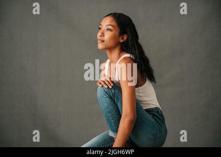 Close up American African female sitting and thinking Stock Photo