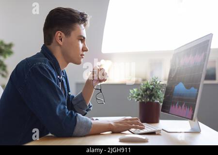 Financial Analytics. Millennial Male Entrepreneur Working With Computer In Office Stock Photo
