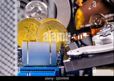 close-up of gold bitcoin on computer components background, technology and digital currency concept Stock Photo