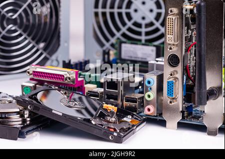 fragment of computer circuit board with components on the background of defocused power supply fans Stock Photo