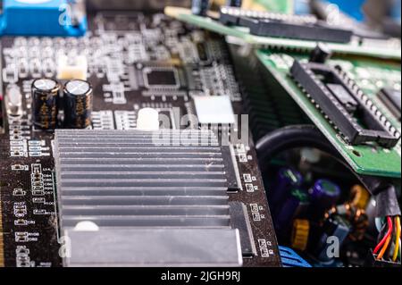 electronic circuit and cooling fin at computer video card, stack with used video cards, close-up Stock Photo