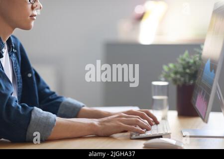Young Man Trading Online, Checking Financial Statistics While Working On Computer Stock Photo