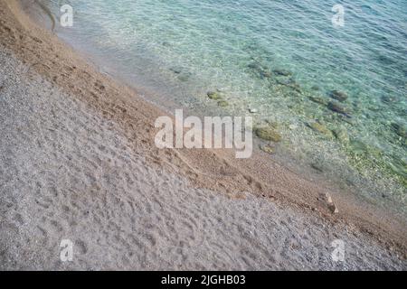 Soft blue ocean wave on clean sandy beach, background Stock Photo