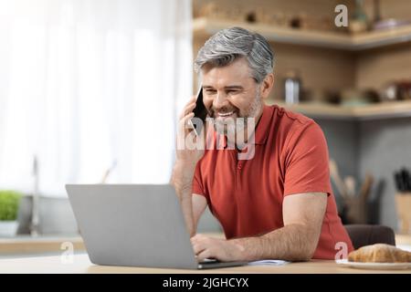 Handsome middle aged businessman working from home Stock Photo