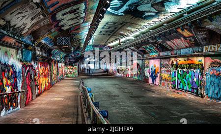 Leake Street, underground tunnel in London iits walls are covered in graffiti and is tolerated regardless of the fact that it is against the law.. Stock Photo