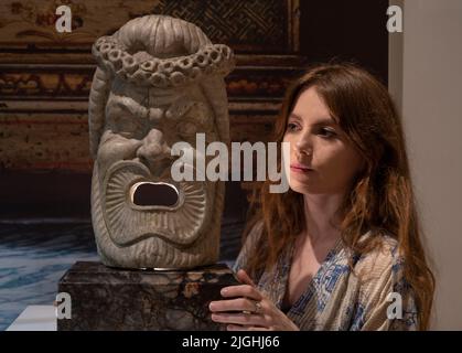 Bonhams, London, UK. 11 July 2022. The Grand Tour Sale takes place on 14 July. Highlights include: A carved grey marble theatre mask after the antique, probably Italian, 18th century, the base of a later date, £8,000-12,000. Credit: Malcolm Park/Alamy Live News Stock Photo