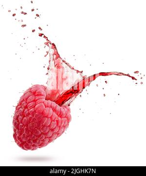 red juice splashing out of a raspberry isolated on white background Stock Photo