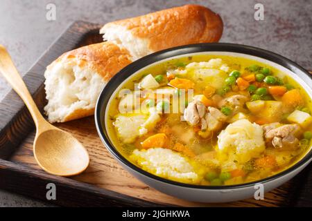 Croatian homemade chicken soup with vegetables and semolina dumplings close-up in a bowl on the table. horizontal Stock Photo