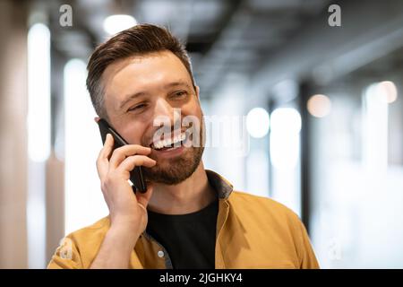 Smiling Business Man Talking On Phone Communicating At Workplace Stock Photo