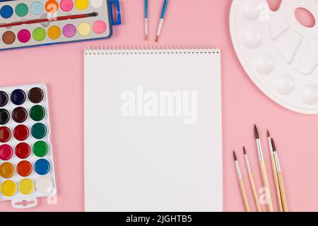 Back to school. Brushes, paints and palette on the table. A set of brushes of different sizes, bright multi-colored paints for drawing on a beautiful Stock Photo