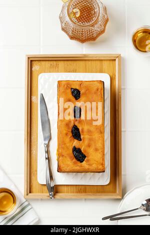 Top View Lapis Surabaya or Surabaya Layer Cake Served with Tea. Spiku is Three  Layers Rich Egg Yolk Sponge Cake with Strawberry Jam in Between and Pl Stock Photo