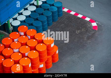 Top view oil barrels green and orange or chemical drums horizontal stacked up Stock Photo