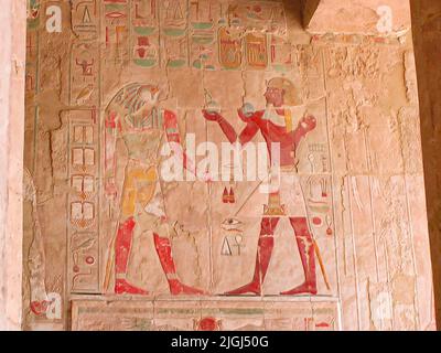 cartouches and low relief -wall paint of pharaoh offering a gift to god horus - hatshepsout temple deir el-bahari (thebes), egypt, africa Stock Photo