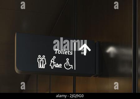 Modern public toilet sign on the wall Stock Photo