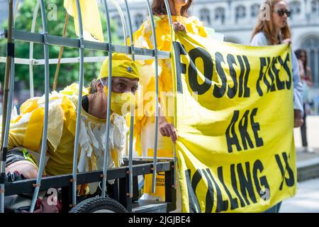 London, UK.  11 July 2022.  Members of Extinction Rebellion (XR), dressed as canaries in a coal mine, take part in a protest in Parliament Square calling for a stop to new coal mines in the UK. Credit: Stephen Chung / Alamy Live News Stock Photo