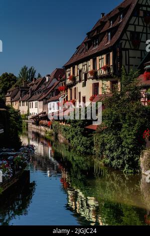 Colourful Little Venice (La Petite Venise) at Colmar, Alsace, Grand Est, France, blends spectacular timber-framed houses and hotels with waterside restaurants along the canalised River Lauch, which is busy in the tourist season with flat-bottomed boats carrying visitors on guided tours. Stock Photo