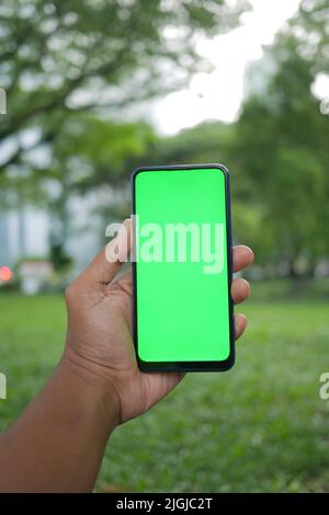 rear view of young man using smart phone at outdoor  Stock Photo