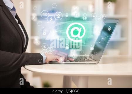 Hands working on laptop with digital icons concept Stock Photo