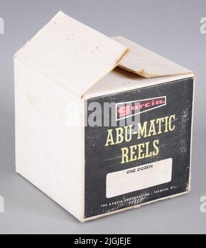 Förpackning Packaging, cardboard, for fishing rolls. Cube -shaped. White with two black sides. Text including "Garcia Abu-Matic Reels One Dozen". Has contained 12 "Abu-Matic". Gift of Abu, Svängsta 1967-01-09 Stock Photo