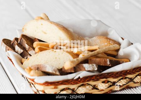 Dish with bread and breadsticks on white Stock Photo