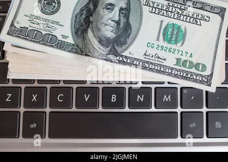 Batch of one hundred dollar bills on keyboard Stock Photo