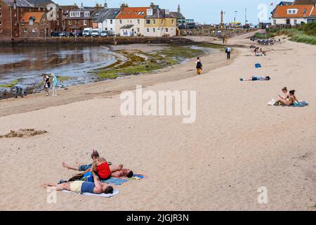 North Berwick, East Lothian, Scotland, 11th July 2022.UK Weather: warm hazy sunshine at the beach: families enjoy a very warm day at the seaside in the Firth of Forth with people sunbathing on the sandy beach Stock Photo