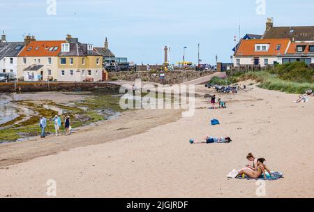 North Berwick, East Lothian, Scotland, 11th July 2022.UK Weather: warm hazy sunshine at the beach: families enjoy a very warm day at the seaside in the Firth of Forth with people sunbathing on the sandy beach Stock Photo