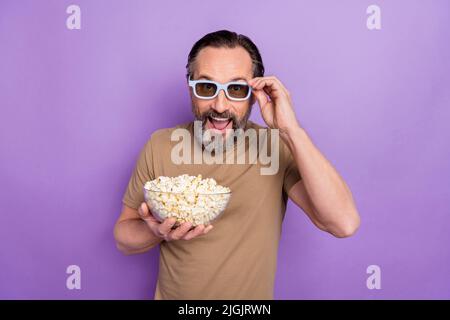 Photo of astonished man in 3d glasses watching comedy film laughing having fun isolated on purple color background Stock Photo