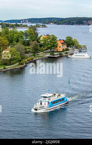 The passenger ship 'Sjovagen' passing the ferry at Blockhusudden on Djurgården Island in the Stockholm Archipelago, Sweden Stock Photo