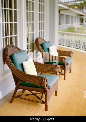 Two wicker chairs on a wrap around porch at the Four Seasons Resort Lana'i, The Lodge at Koele. Lana'i, Hawaii, USA. Stock Photo
