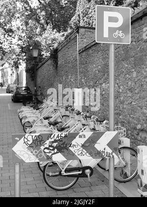 Multiple bycicles parking on the street Stock Photo