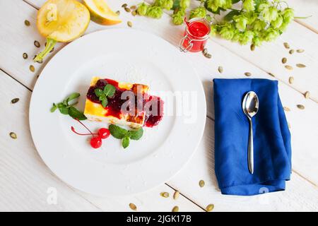 Plate with dessert and spoon on napkin flat lay Stock Photo