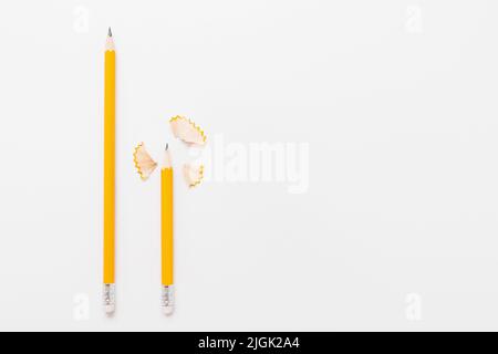 Long and short pencils with shavings on white Stock Photo