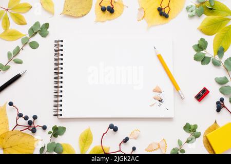 Sketchbook with pencil in autumn leaves frame Stock Photo