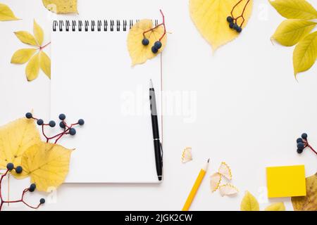 Blank notepad with pen in autumn leaves frame Stock Photo