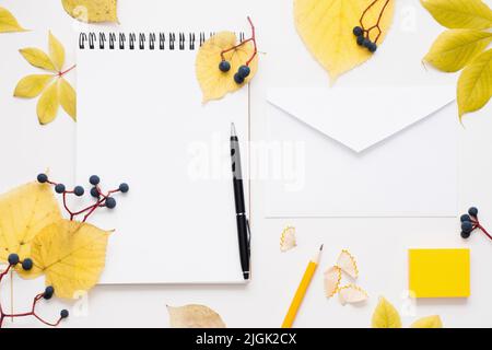 Blank notepad and envelope in autumn leaves frame Stock Photo