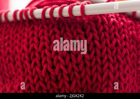 Red ball of yarn with needles close-up Stock Photo