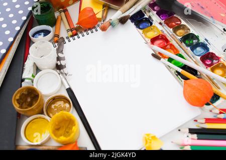 Blank sketchbook with paints and brushes, mockup Stock Photo