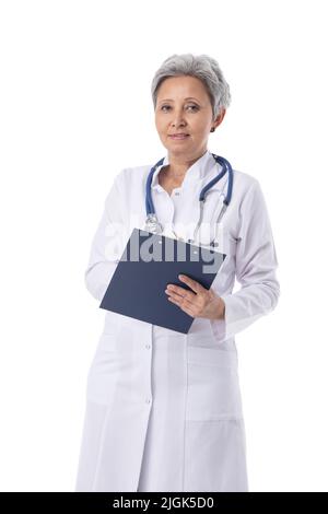 Asian mature female medical doctor with stethoscope taking notes holding document folder isolated on white background Stock Photo