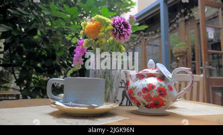 A photo of a tea service in a garden Stock Photo